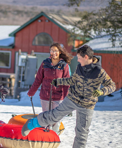 Kids Carry Tubs to Tubing Hill