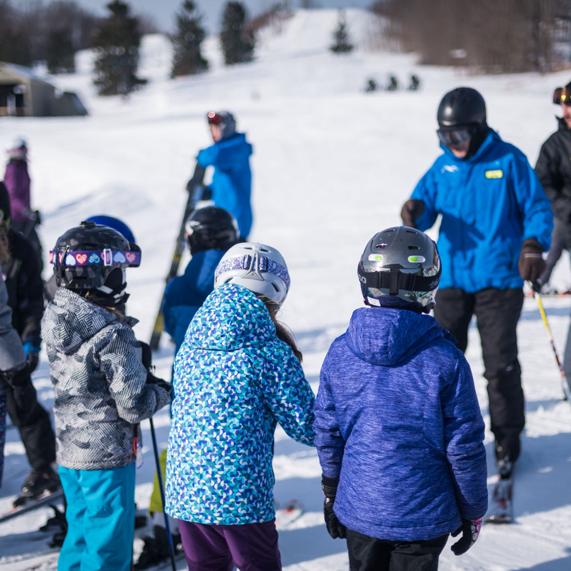 Group of Children Listen to Ski Instructors at Alpine Valley