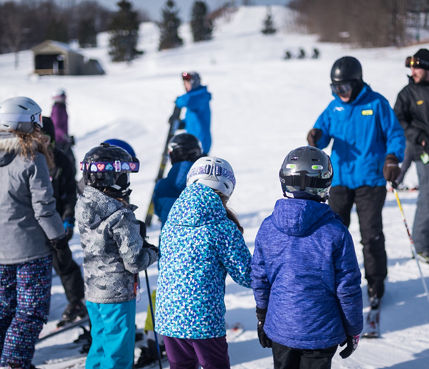 Group of Children Listen to Ski Instructors at Alpine Valley