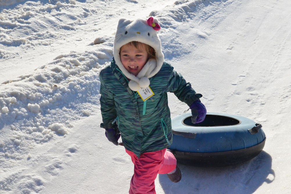 Little Girl Pulls Tube on Tubing Hill at Snow Creek
