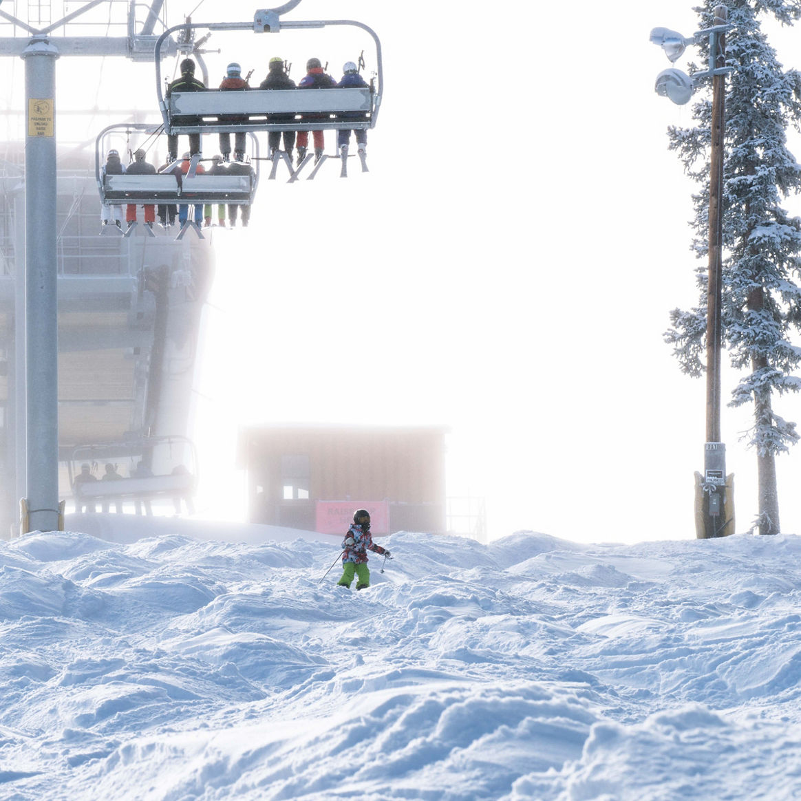 Skiers ride on Dercum in the snow in Keystone, CO.