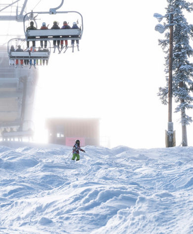 Skiers ride on Dercum in the snow in Keystone, CO.