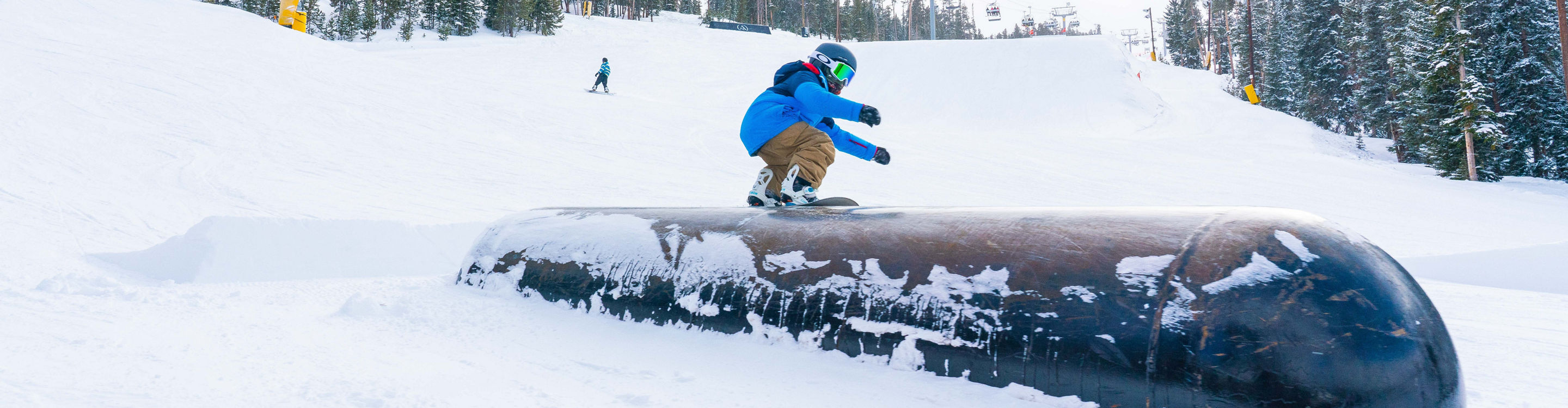 Father and son ride Easy Street in A51 terrain park in Keystone, CO.