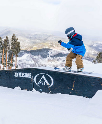 Father and son ride Easy Street in A51 terrain park in Keystone, CO.