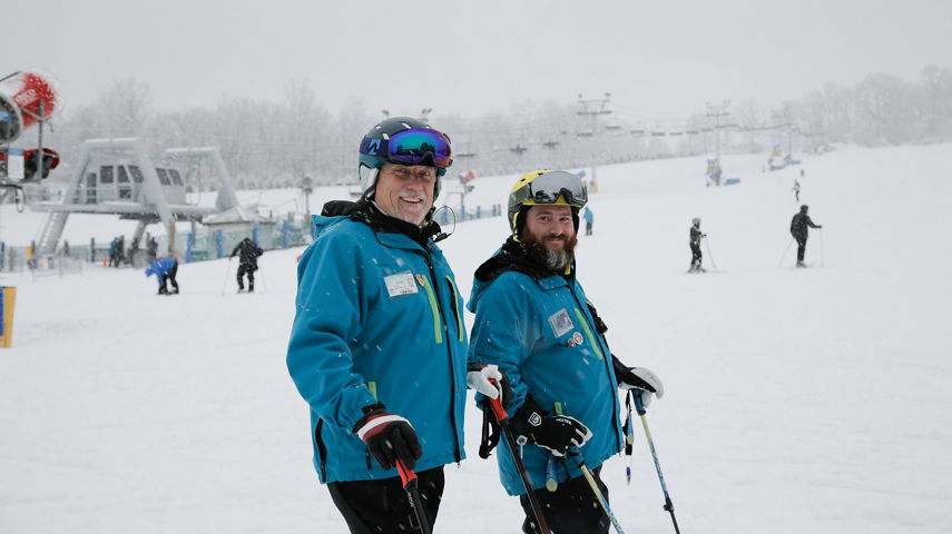 Two Ski Instructors Pose at Liberty Mountain