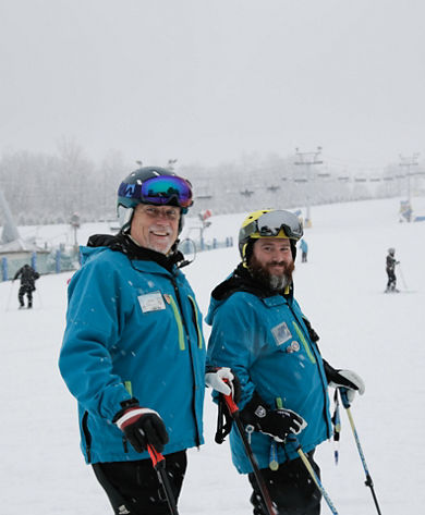 Two Ski Instructors Pose at Liberty Mountain