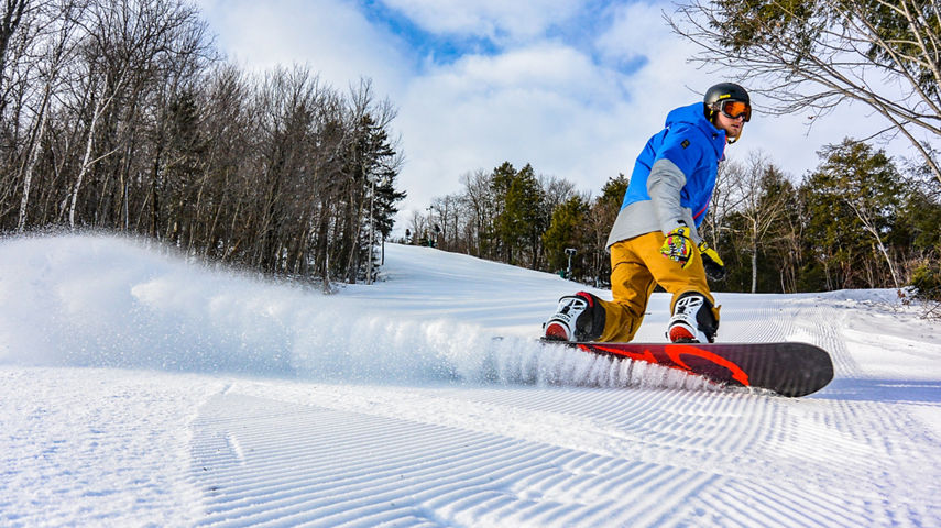 Snowboarder Makes Turns on Groomed Runs at Crotched Mountain