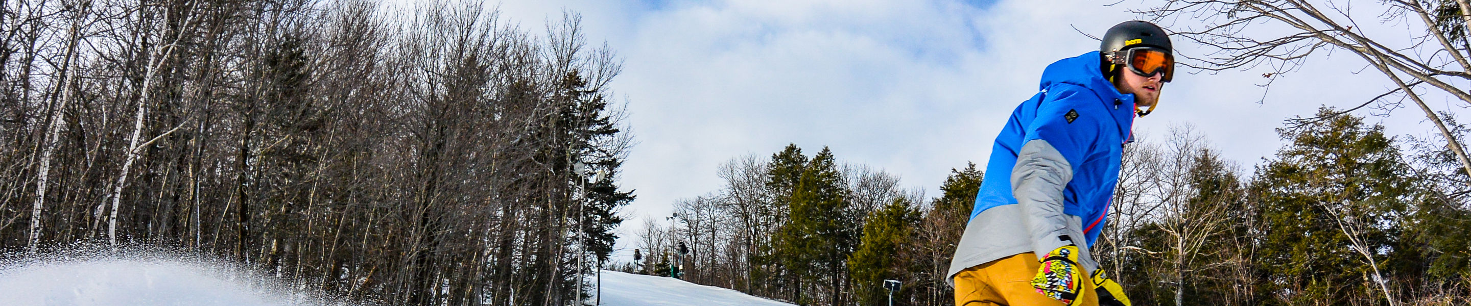 Snowboarder Makes Turns on Groomed Runs at Crotched Mountain