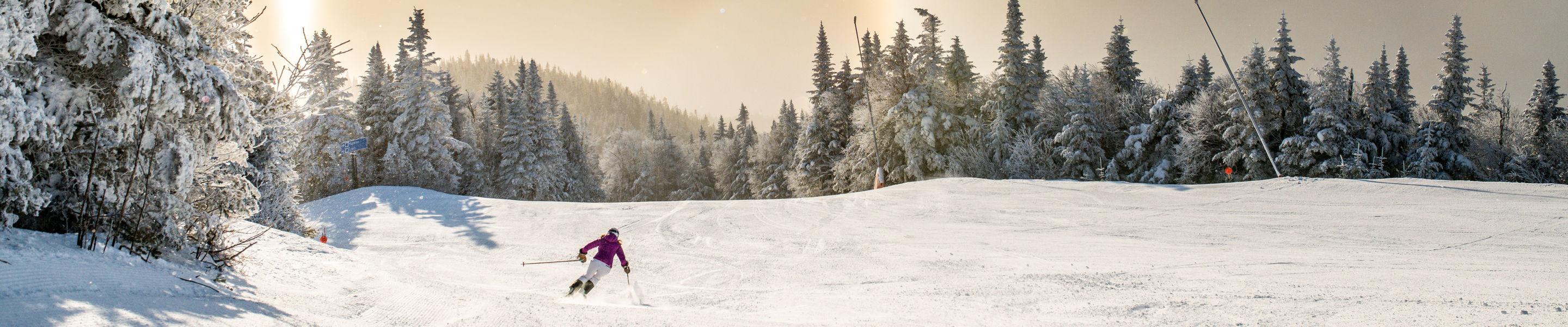 Woman Skis Down Sunrise Trail at Stowe Mountain Resort