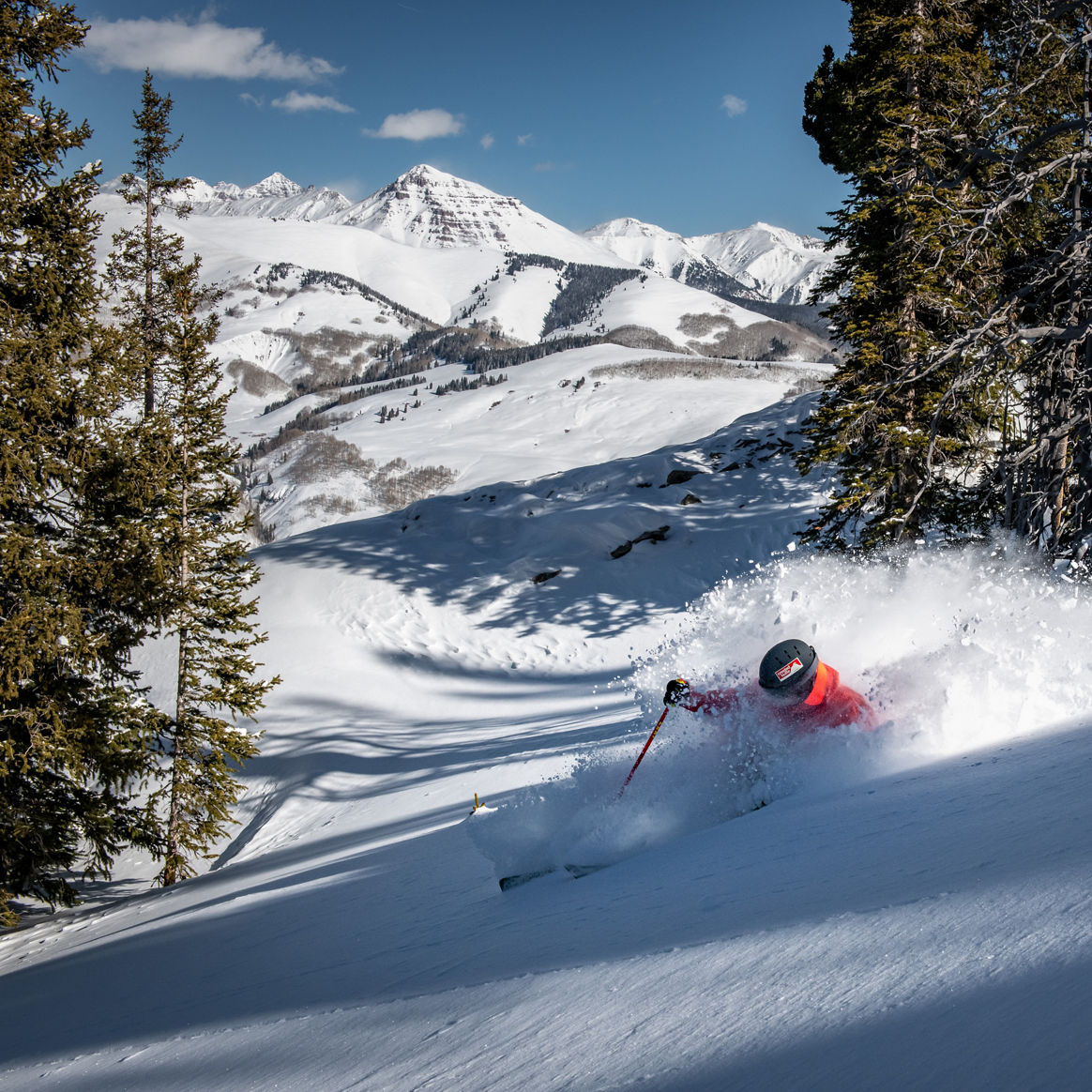 Skier making deep powder turn off the North Face Lift at Crested Butte 