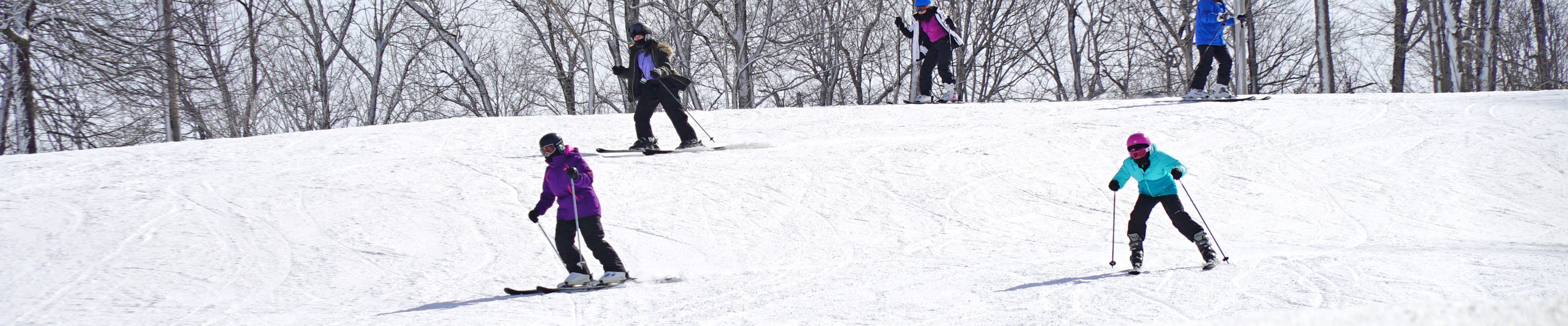 Group of Skiers Turns Downhill at Mad River Mountain