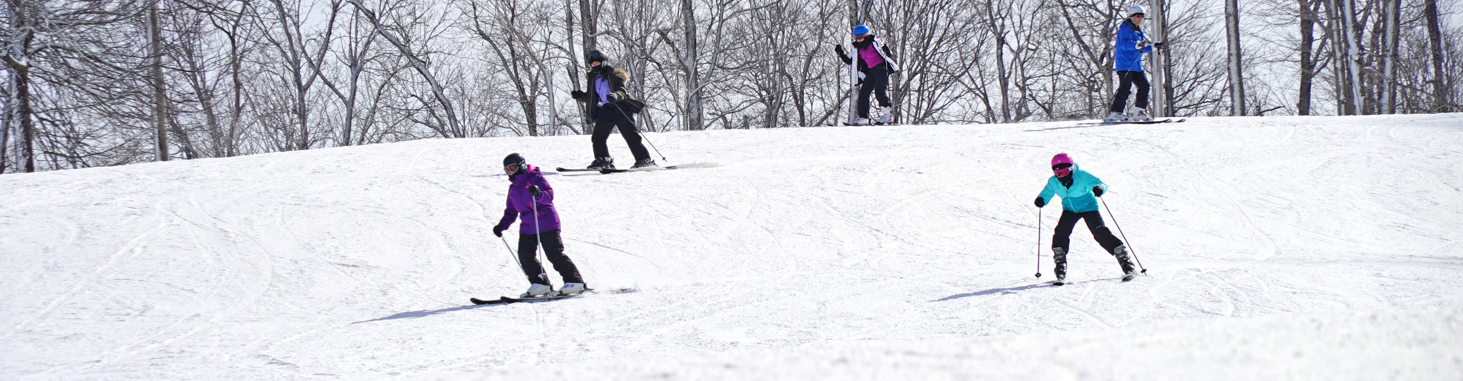 Group of Skiers Turns Downhill at Mad River Mountain
