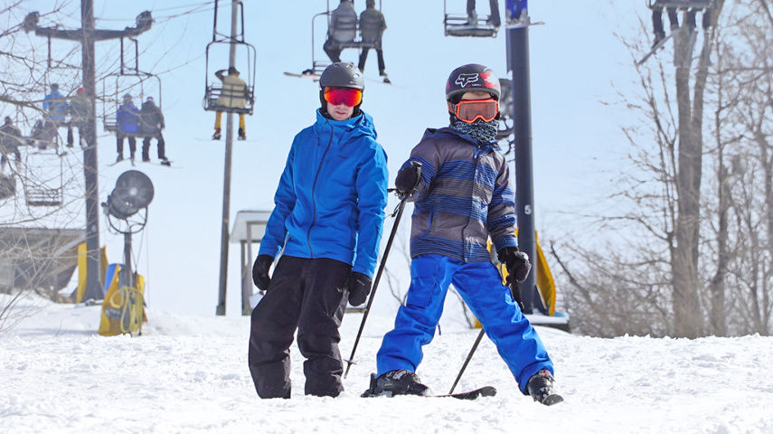 Skier and Rider Under Chairlift at Mad River Mountain