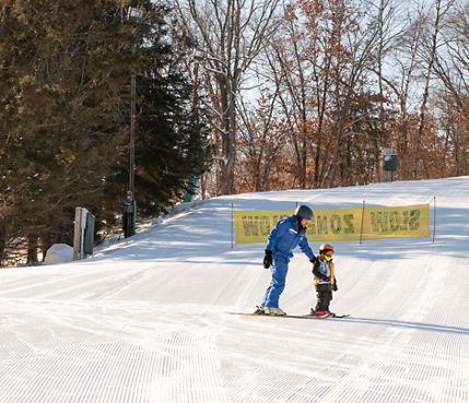 Instructor Helping Little Kid on Kitty's Garden at Afton Alps