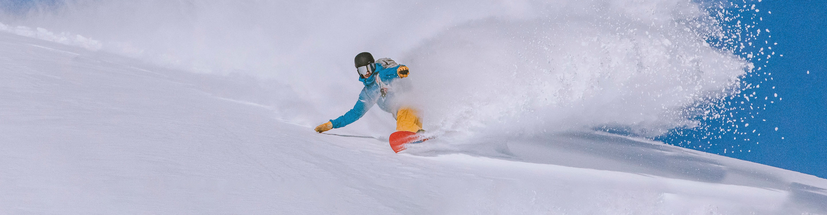 Snowboarding through powder in Kirkwood