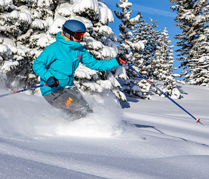 Lady Skis Through Trees on a Powder Day at Northstar California
