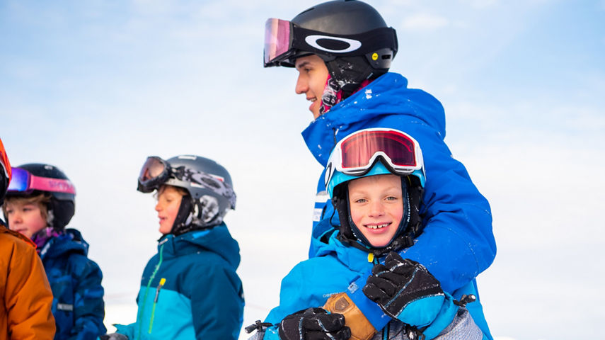 Ski student child smiling at camera with group in Crested Butte