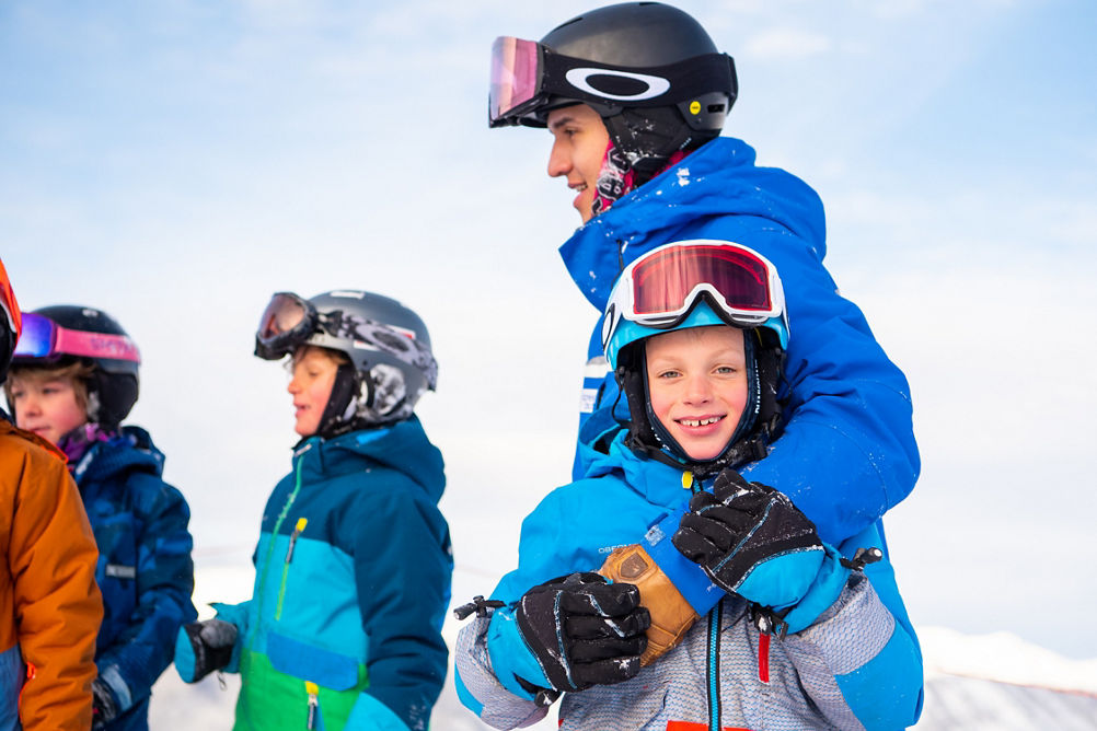 Ski student child smiling at camera with group in Crested Butte