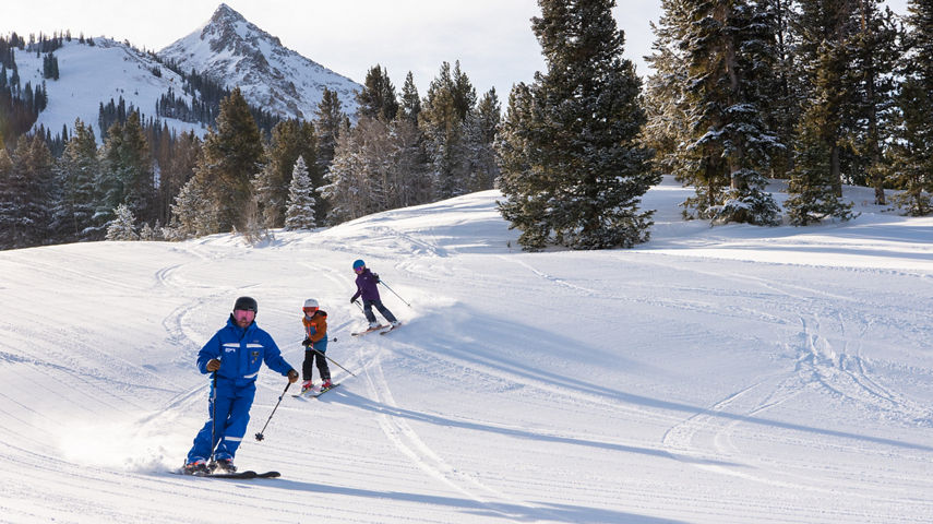 Instructor leading kids ski group at Crested Butte