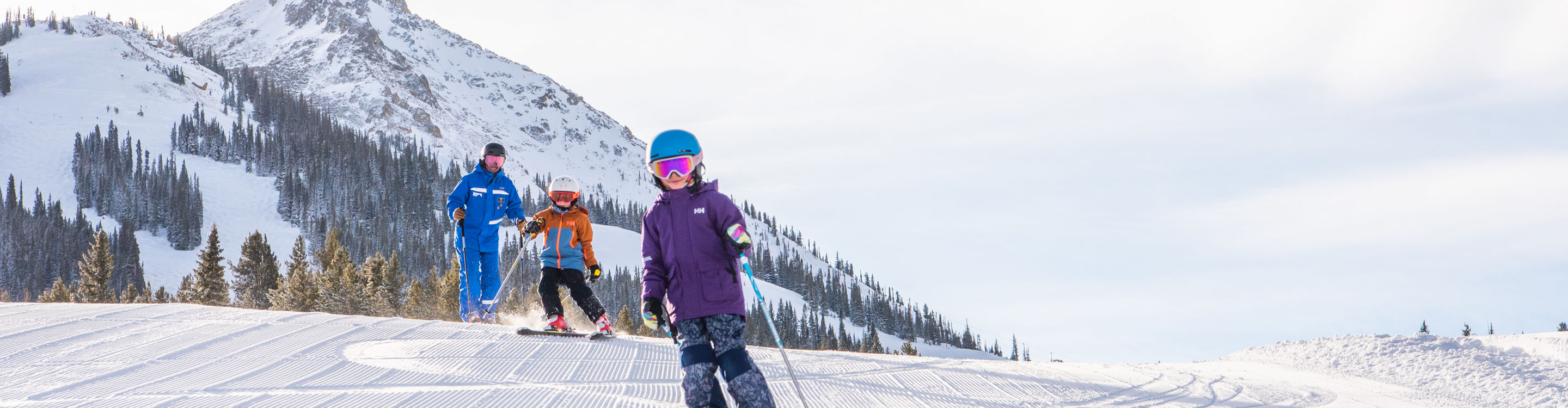 Kids ski group skiing corduroy at Crested Butte