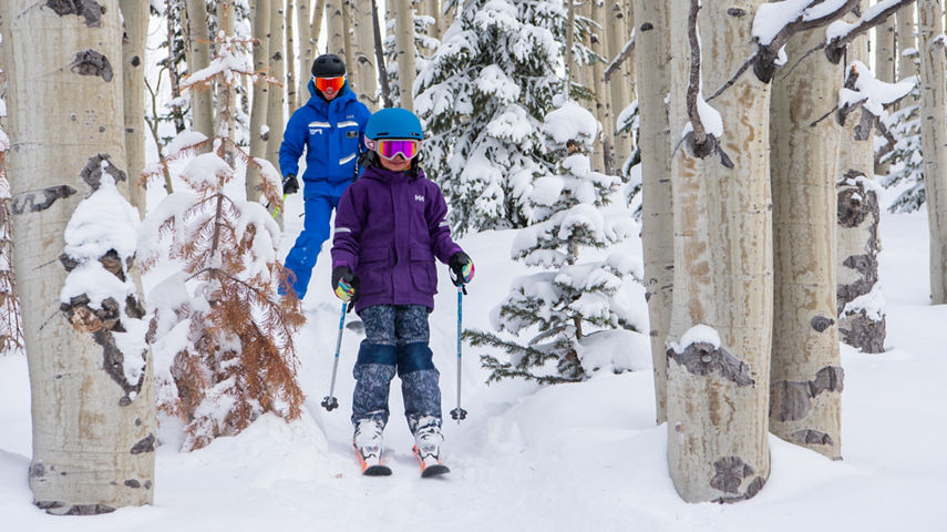 Kids ski group in snowy trees at Crested Butte