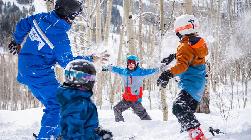 Kids ski group throwing snowballs in Crested Butte