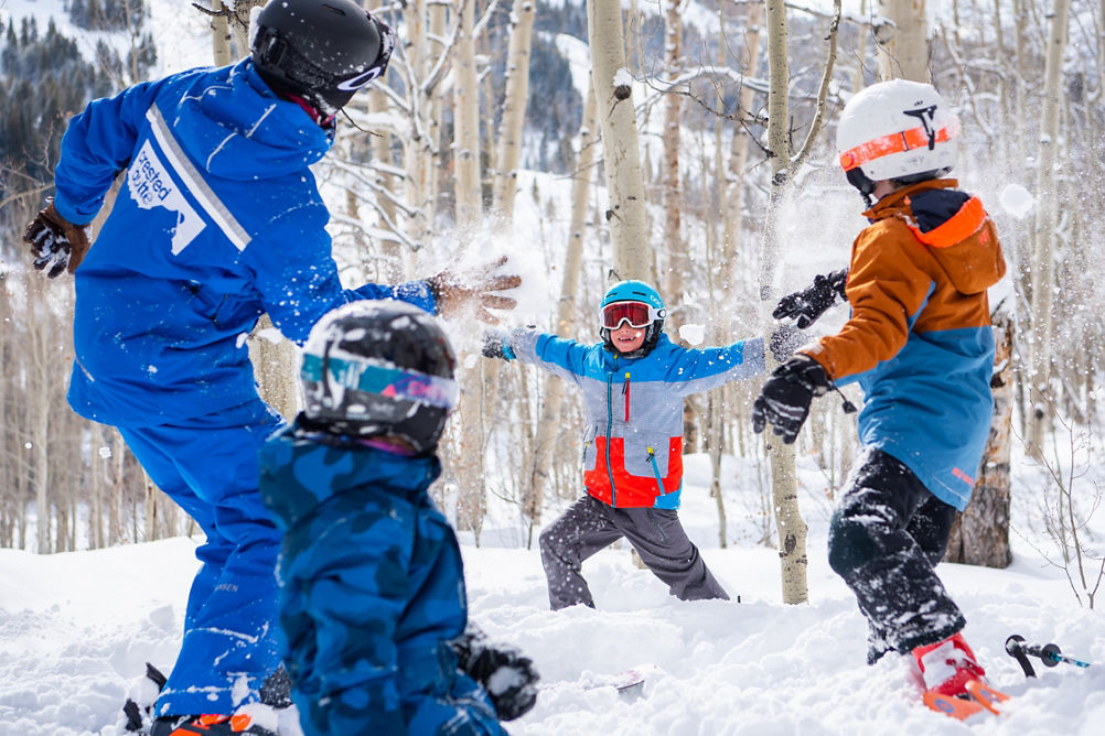 Kids ski group throwing snowballs in Crested Butte