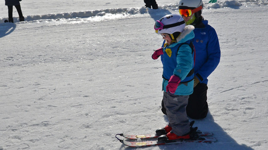 Ski Instructor Helps Little Girl Learn How to Ski at Snow Creek