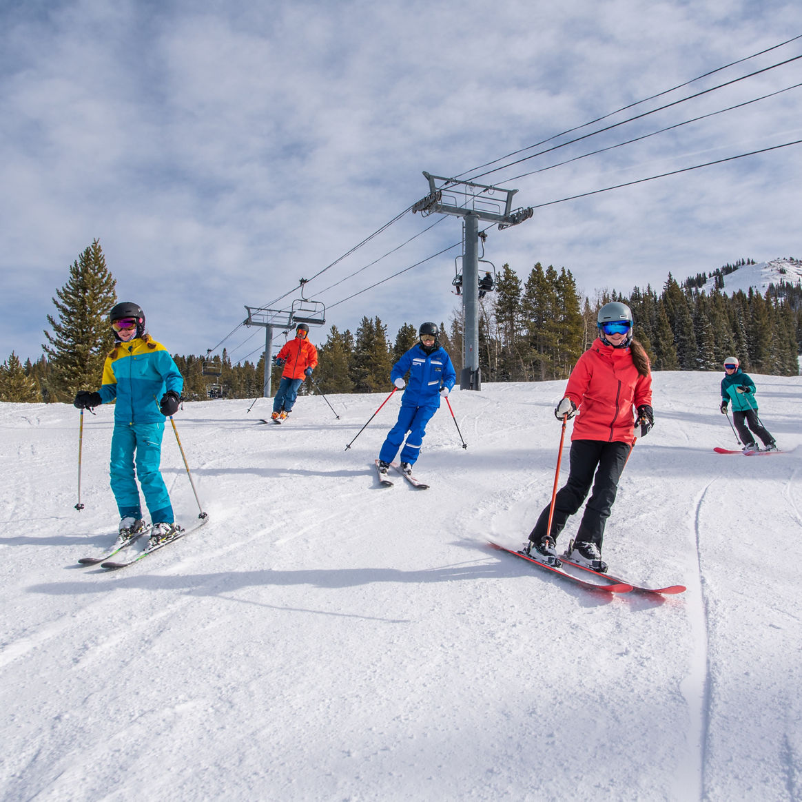 Private family lesson skiing with peak in background at Crested Butte
