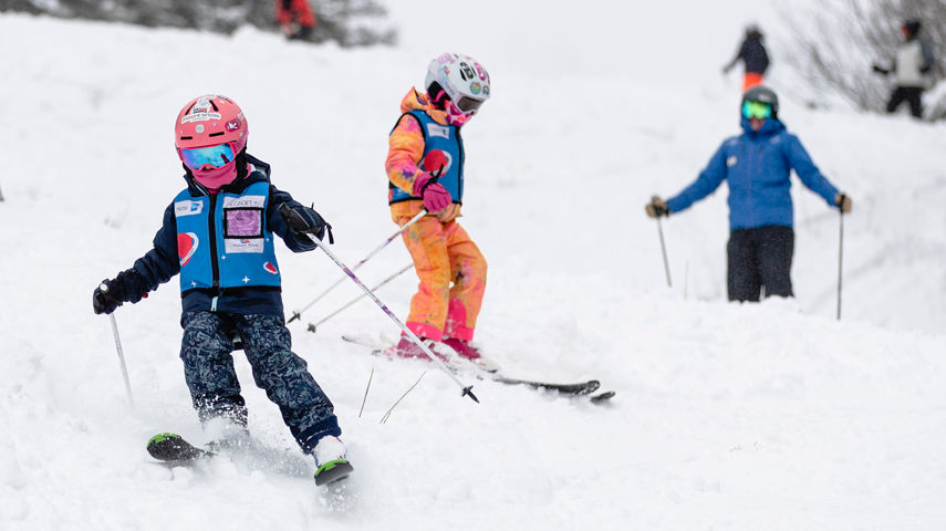 Group of Ski School Lesson Skiers Turn in Fresh Snow at Mount Snow