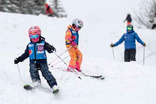 Group of Ski School Lesson Skiers Turn in Fresh Snow at Mount Snow