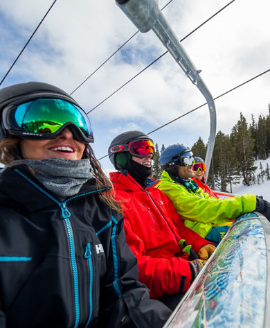 Four friends ride up chairlift at Breck