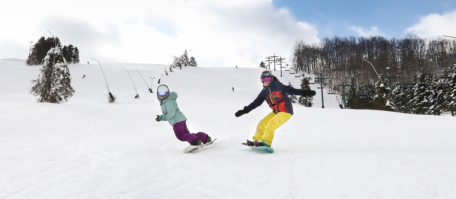 2 female snowboarders on NF
