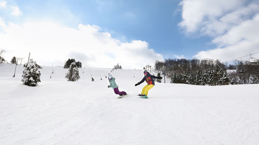 2 female snowboarders on NF