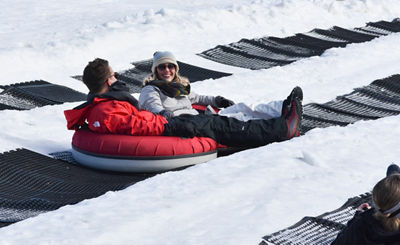 Couple Holds Hands and Tubes Together at Paoli Peaks