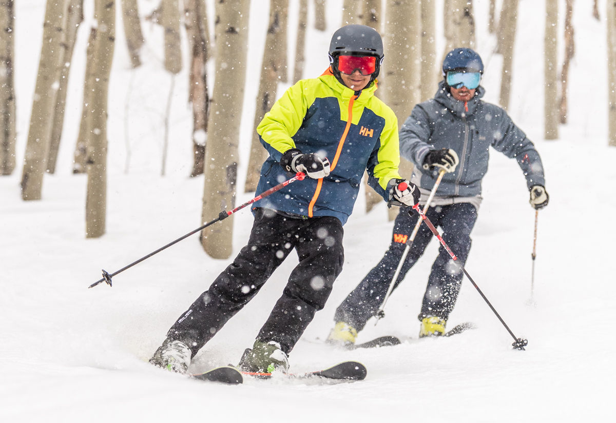 Family skiing through aspens
