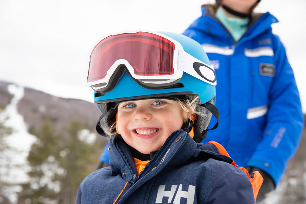 Child Skier Smiling into Camera at Mount Sunapee