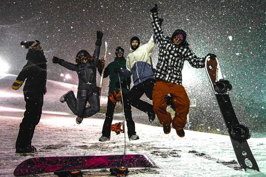 Group of Snowboarders Pose at Night at Boston Mills