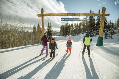 4 skiers skiing down Beaver Creek Mountain