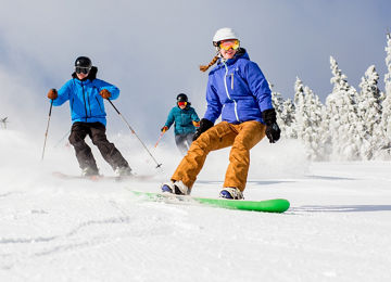 Group of Skiers and Riders on Ski Run at Mount Snow