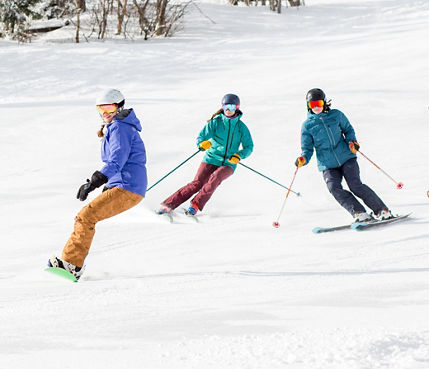 Group of Skiers and Riders on Ski Run at Mount Snow