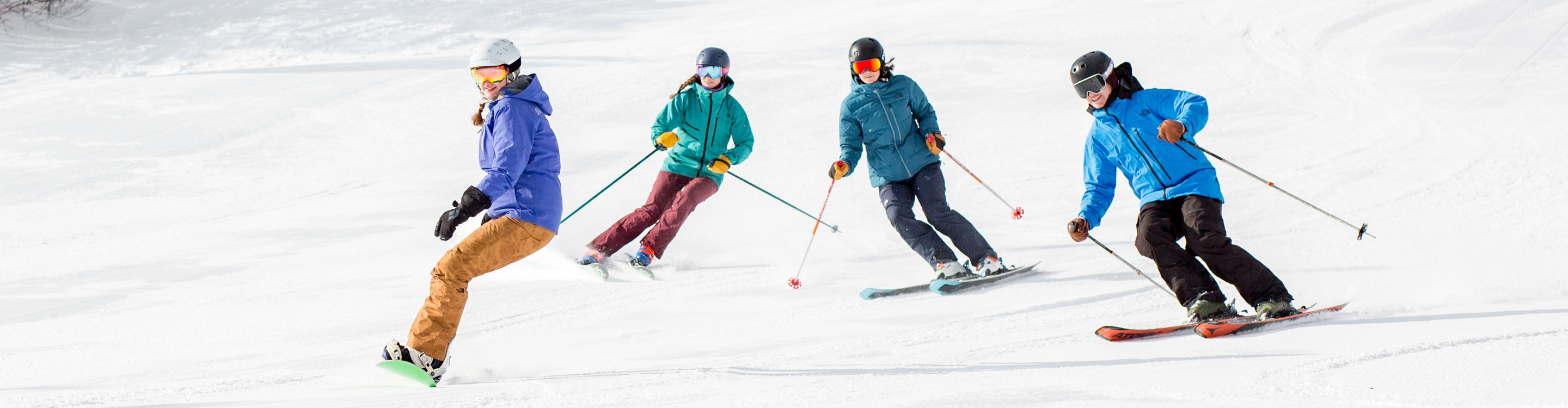 Group of Skiers and Riders on Ski Run at Mount Snow