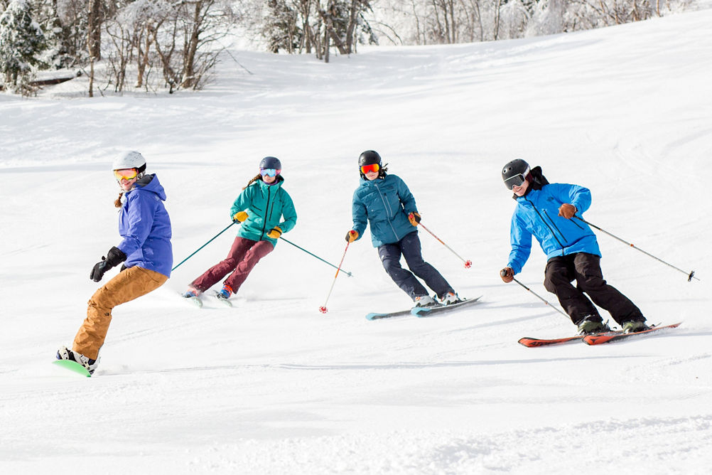 Group of Skiers and Riders on Ski Run at Mount Snow
