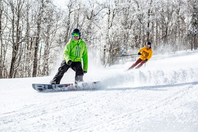 Skier and Rider Make Turns at Mount Snow