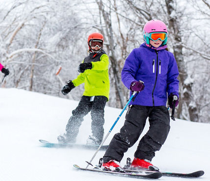 Group of Skiers and Riders on Ski Run at Mount Snow