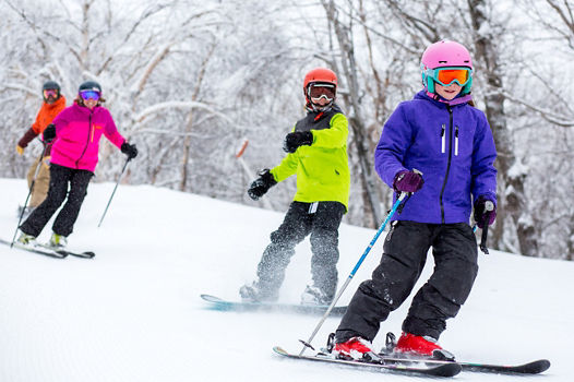 Group of Skiers and Riders on Ski Run at Mount Snow