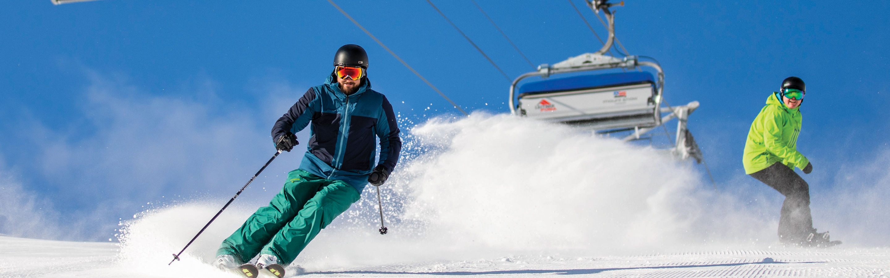 Skier and Rider Make Turns at Mount Snow