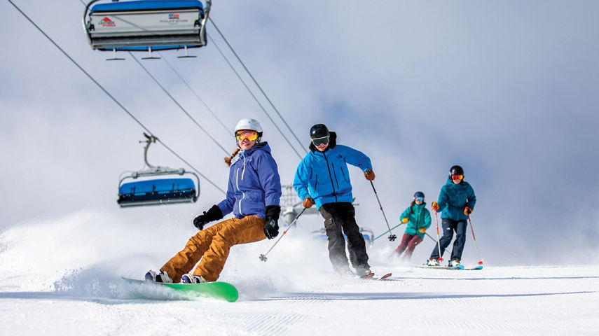 Group of Skiers and Riders on Ski Run at Mount Snow