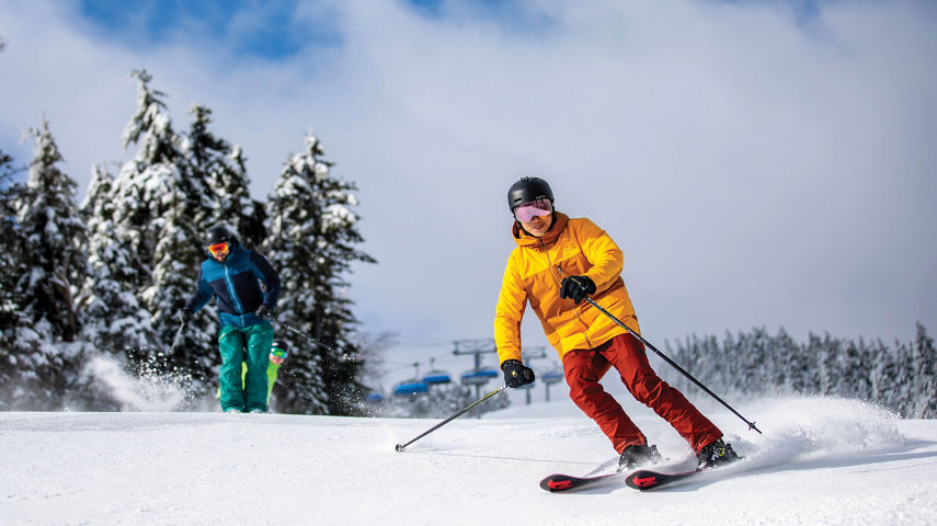 Group of Skiers and Riders on Ski Run at Mount Snow