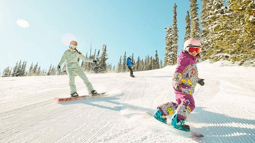 Girls snowboarding during a lesson at Keystone Resort